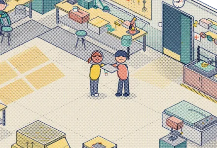 A new engineer handed a laptop and badge at a hardware workshop.